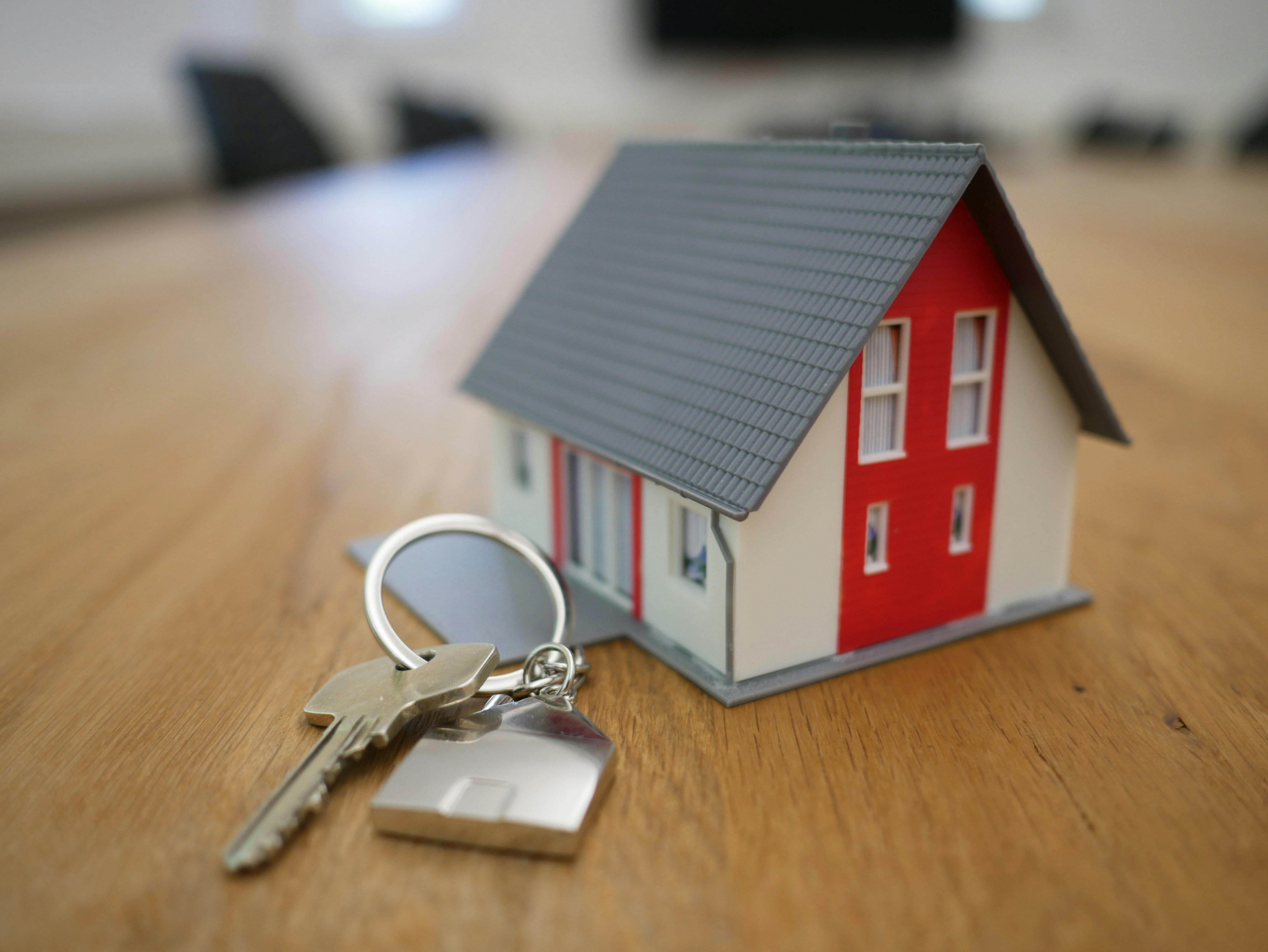 Picture of a small wooden house with keys next to it