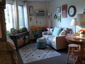 Riverview Heights living room with wall mounted air conditioner and furniture